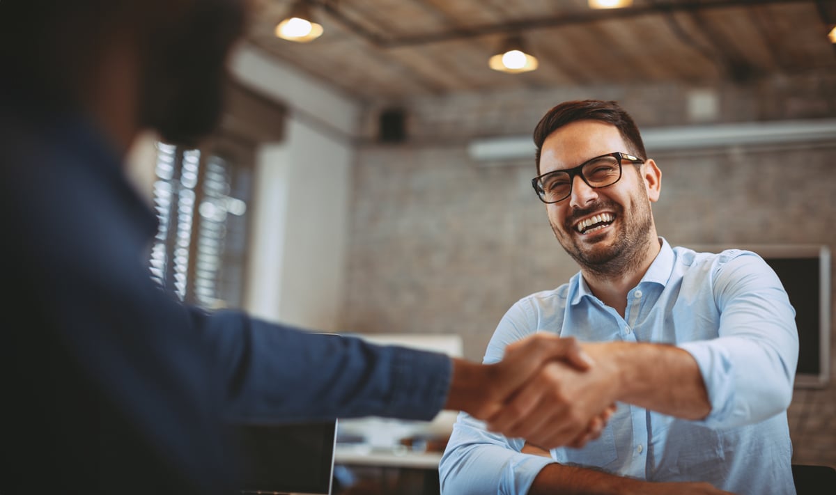 man-smiling-and-shaking-hand